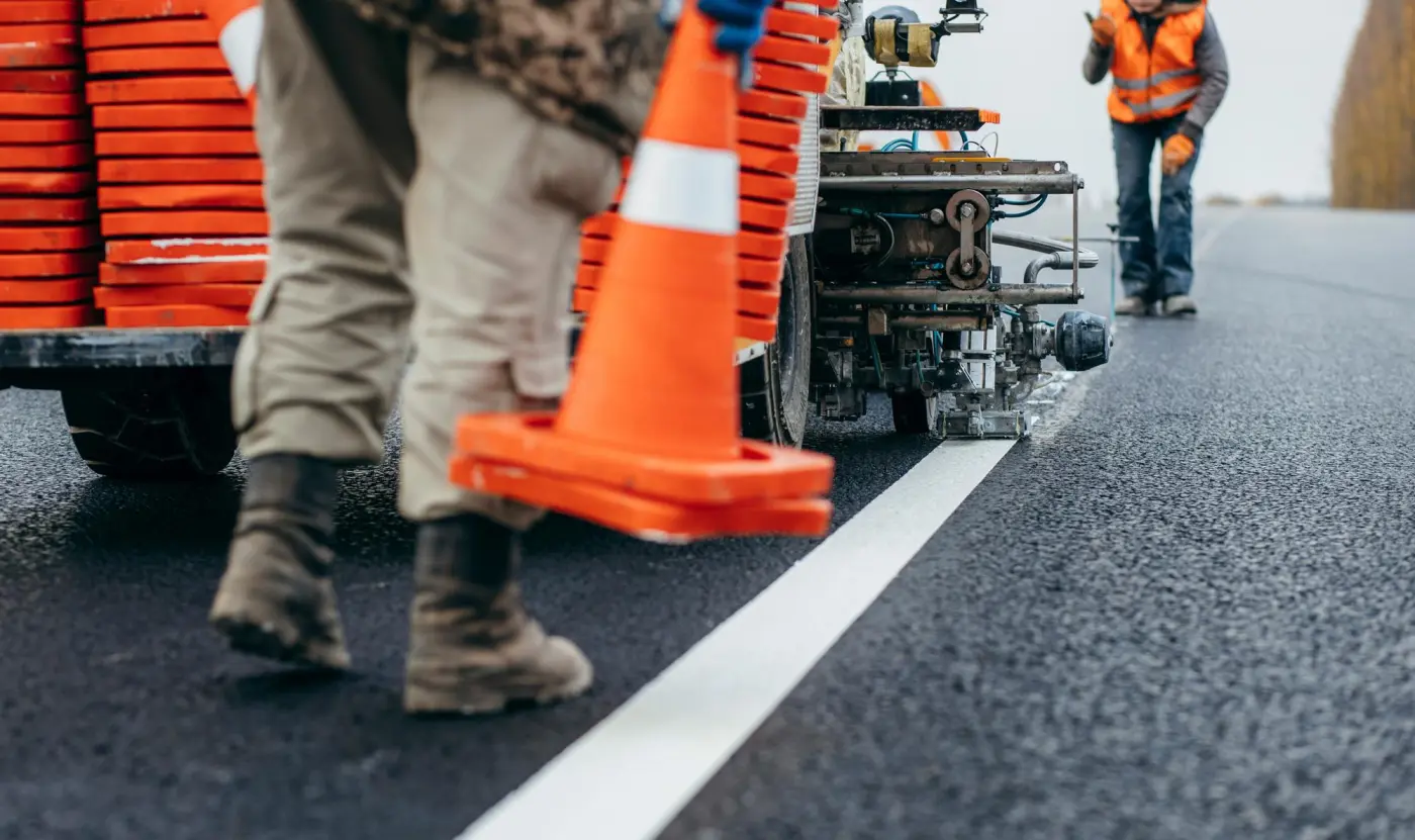 An L&R Roadlines crew laying a new white line on a resurfaced road