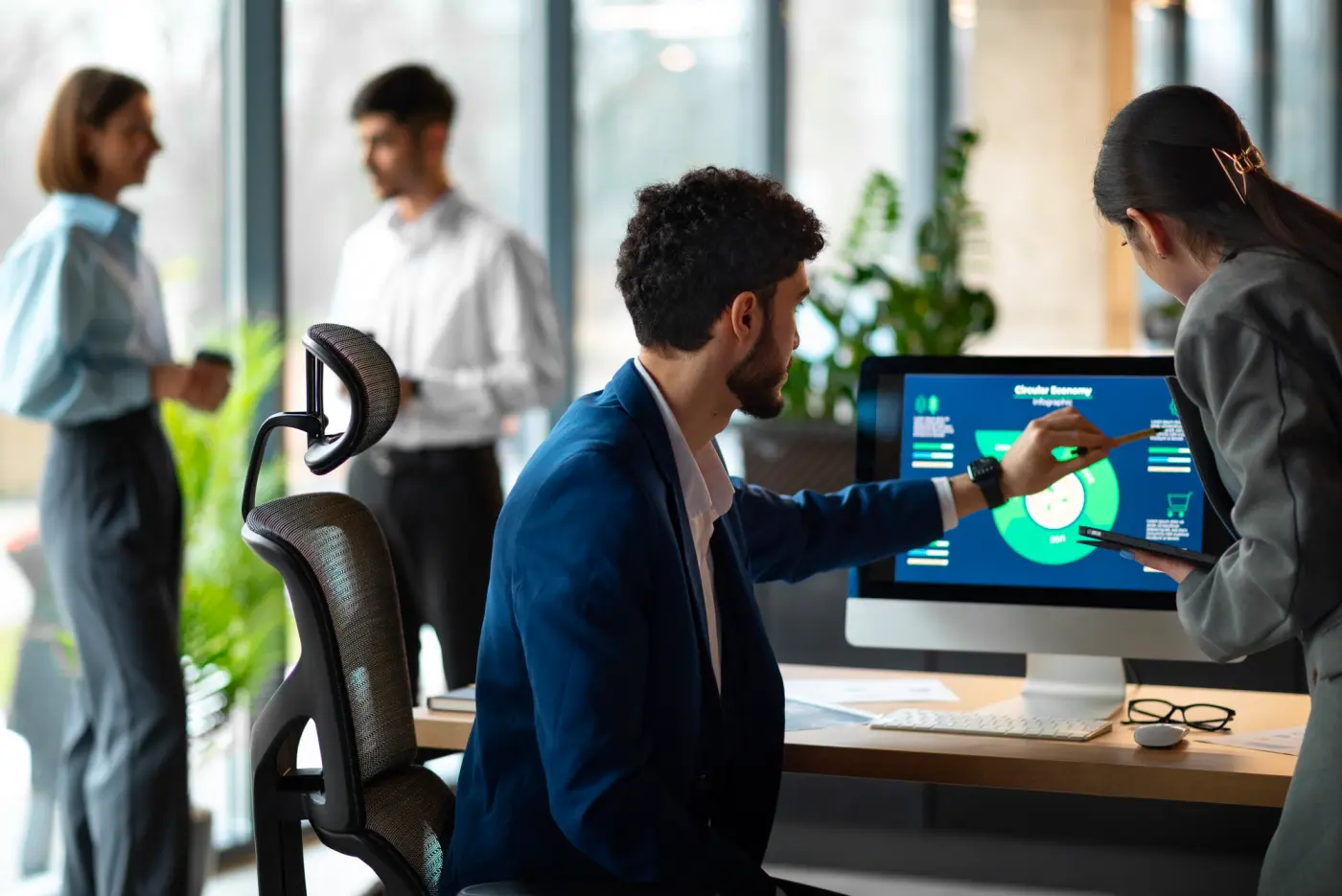 A Triangle Software developer talking a colleague through a project dashboard