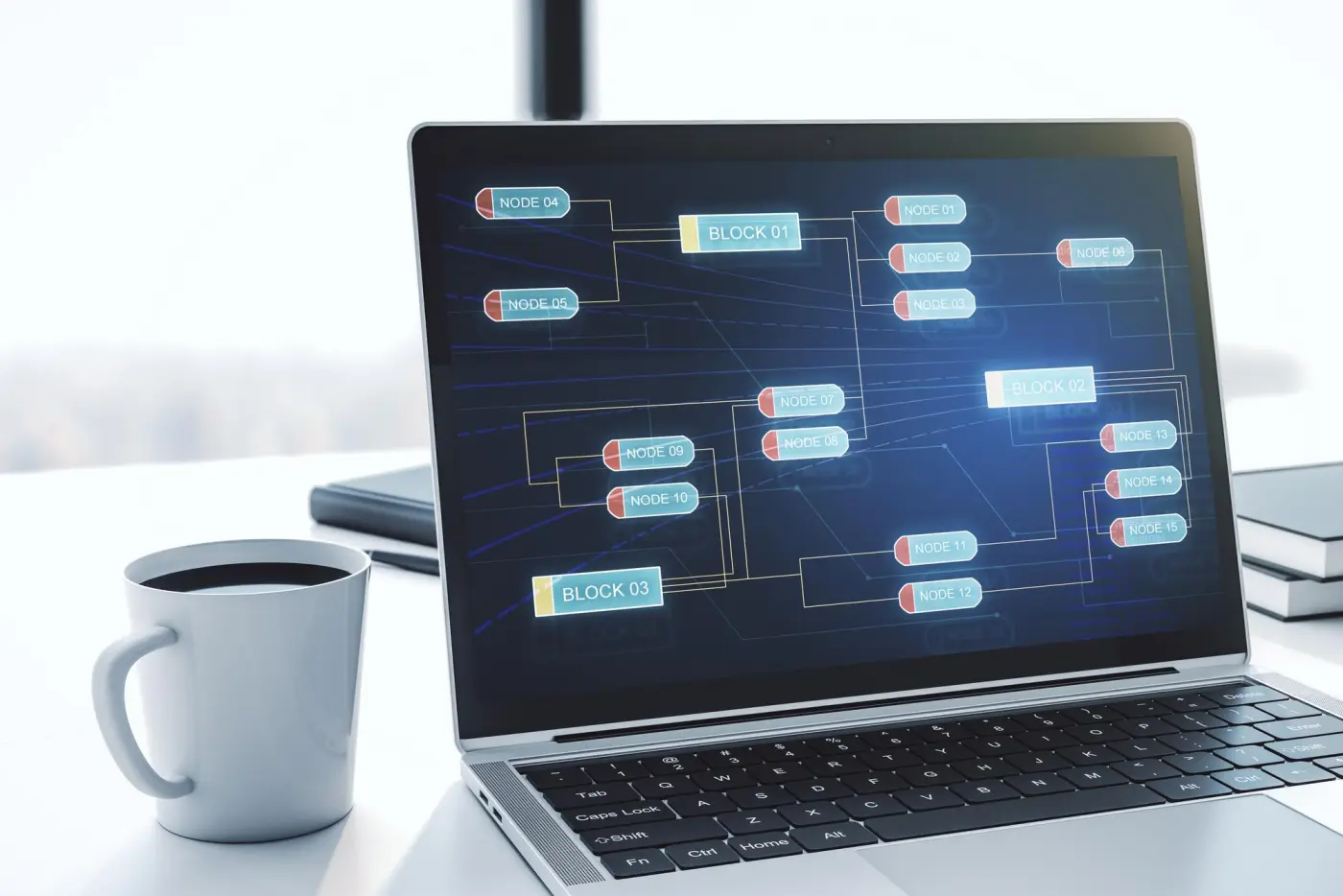 A laptop on a desk showing a diagram of connected system blocks